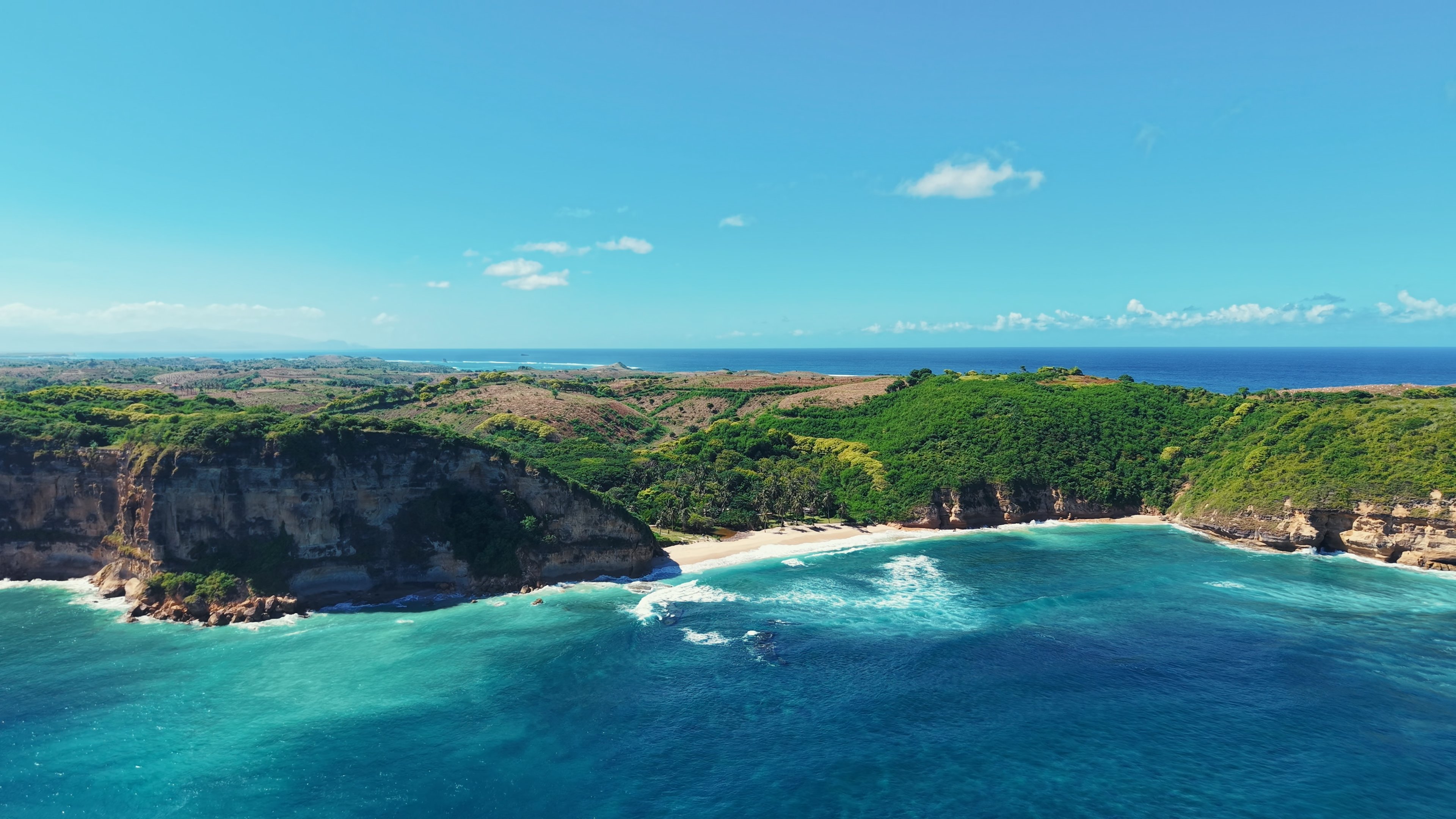 Ocean Heaven — aerial opening shot showing the full beach, cliffs and land